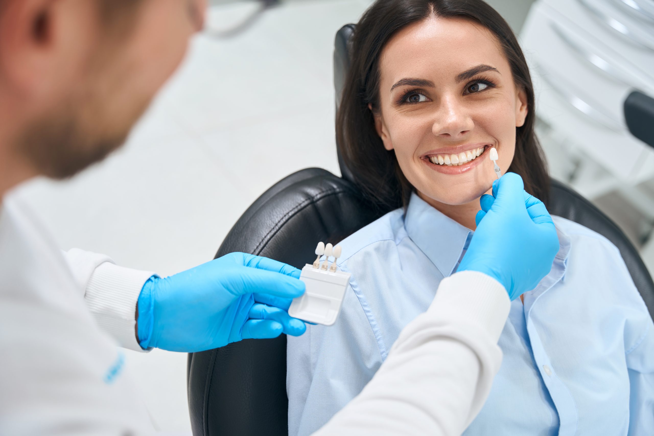High Qualified Dental Technician Choosing Proper Size And Color Of Dental Crown