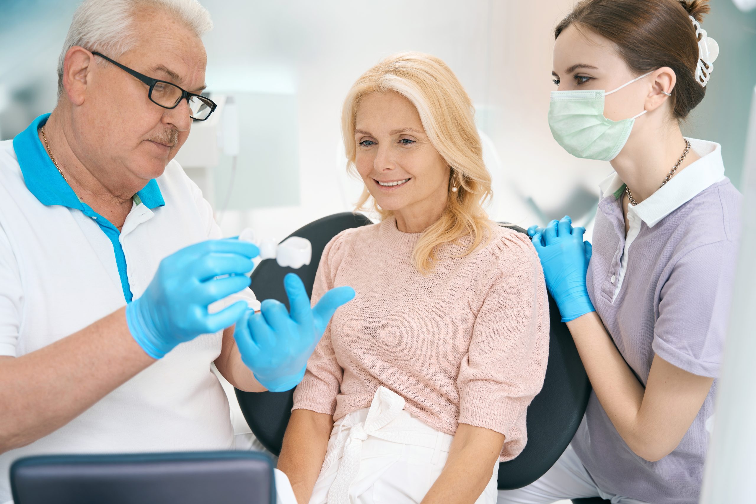 Woman Discussing Details Of Surgery Teeth With Doctor And Nurse